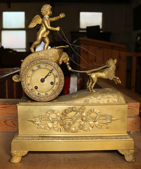 French gilt clock mounted with a cherub on a chariot with dogs